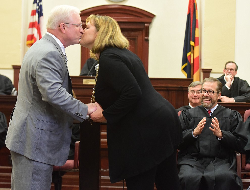 Arizona Supreme Court Justice Robert Brutinel gets a kiss after administering the oath of office to his wife during the Investiture of Jennifer Campbell to the Arizona Court of Appeals Division One at the Yavapai County Courthouse in Prescott Friday, August 11.(Les Stukenberg/The Daily Courier).