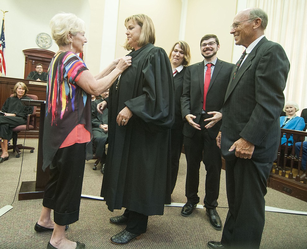 Linda and Colin Campbell along with Holly and Jackson McCrea put the Robe on Justice Campbell during the Investiture of Jennifer Campbell to the Arizona Court of Appeals Division One at the Yavapai County Courthouse in Prescott Friday, August 11.(Les Stukenberg/The Daily Courier).