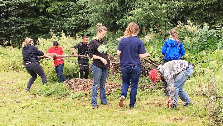 Members of Cottonwood Emmanuel Fellowship Church’s Inside Out Youth Ministries help residents of the Game Creek Farm in southeastern Alaska with general cleanup of the farm. (Courtesy photo)