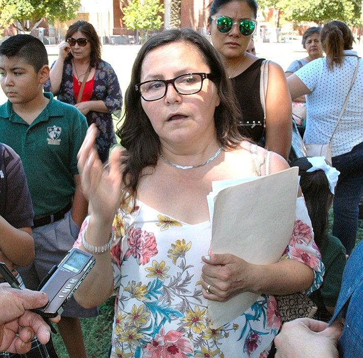 Claudia Gamez of Phoenix expresses her displeasure Tuesday, Aug. 8, at the initiative drive to kill expansion of the voucher program. Gamez said she had hoped to move her four children from a public school to a Catholic school but can afford to do so only if there are vouchers. (Howard Fischer/ Capitol Media Services)
