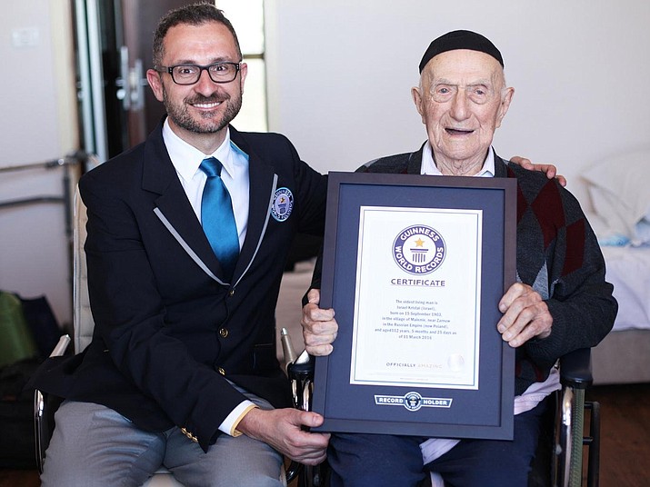 Israel Kristal, 113, receives his certificate from Marco Frigatti, Guinness World Records Head of Records, in March 2016 (Photo courtesy of Guinness World Records)