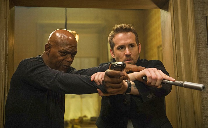 Samuel L. Jackson, left, and Ryan Reynolds star in "The Hitman's Bodyguard." (Jack English/Lionsgate via AP)