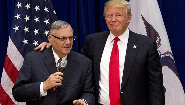 Then-Republican presidential candidate Donald Trump is joined by Joe Arpaio, the sheriff of Maricopa County, Arizona, at a campaign event in Marshalltown, Iowa. Trump is considering pardoning the former sheriff's recent criminal conviction for disobeying a judge's order in an immigration case. The prospect of absolving Arpaio has fueled speculation that Trump will issue his first pardon when he comes to Phoenix next week for a rally.
