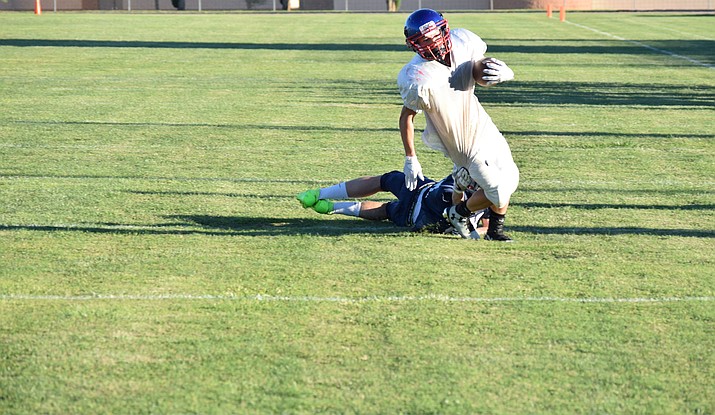 Camp Verde junior Dominiq Bruno sheds a Scottsdale Prep tackle en route to a touchdown on Friday during the Cowboys’ scrimmage at home. Camp Verde opens the season on Friday against Chino Valley at home. (VVN/James Kelley)