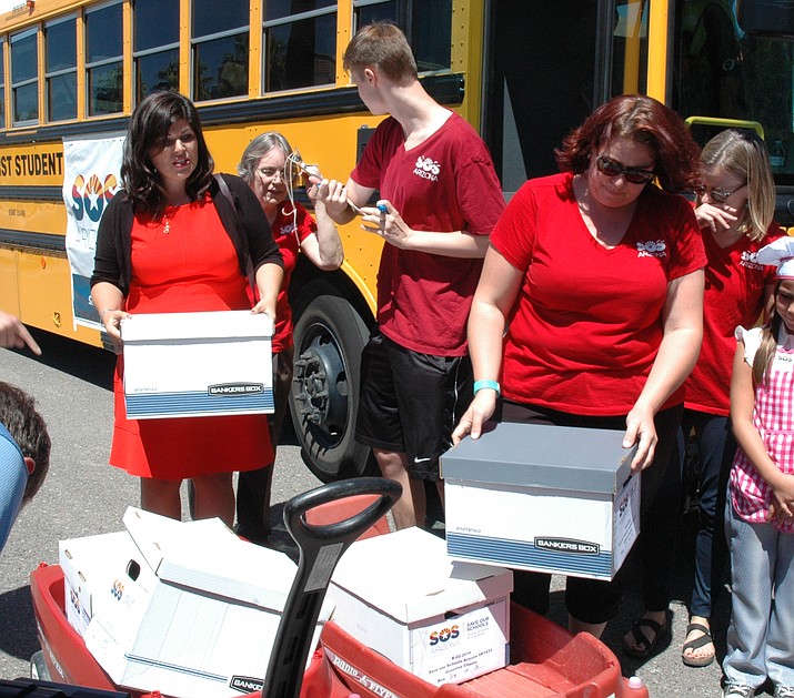 Volunteers collect petitions they had signed by Arizona voters to the Secretary of State’s office earlier this month. They claim to have collected enough to force a vote that would overturn the expansion of school vouchers if it passes. (Howard Fischer/Capitol Media Services)