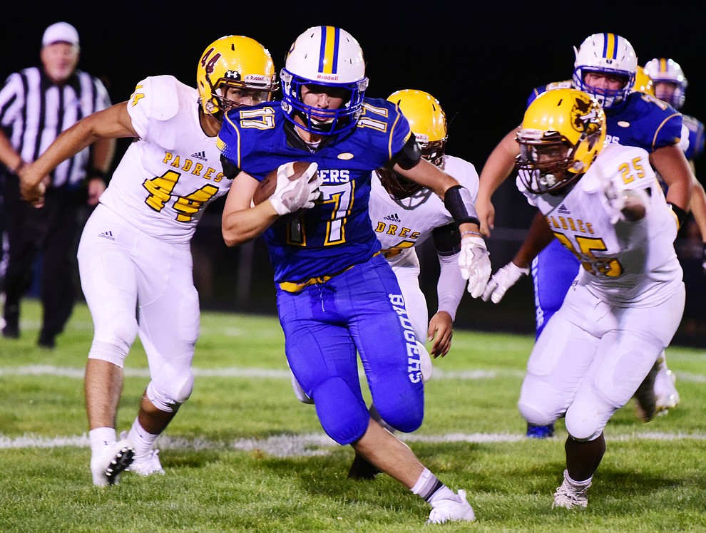 Prescott's Ryan Greene breaks through for a big gain as the Badgers take on the Marcos de Niza in Prescott Friday, August 25. (Les Stukenberg/The Daily Courier)