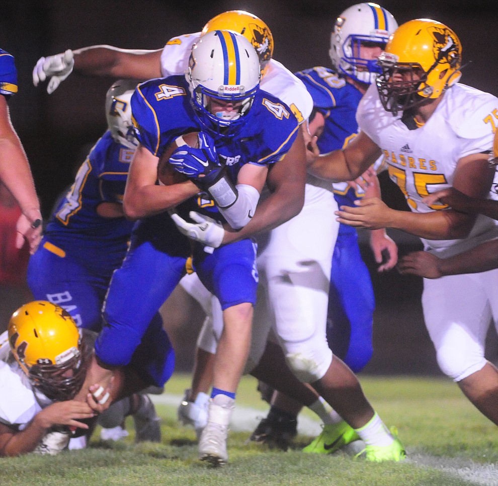 Prescott's Aaron Greene gets stacked up after a gain as the Badgers take on the Marcos de Niza in Prescott Friday, August 25. (Les Stukenberg/The Daily Courier)