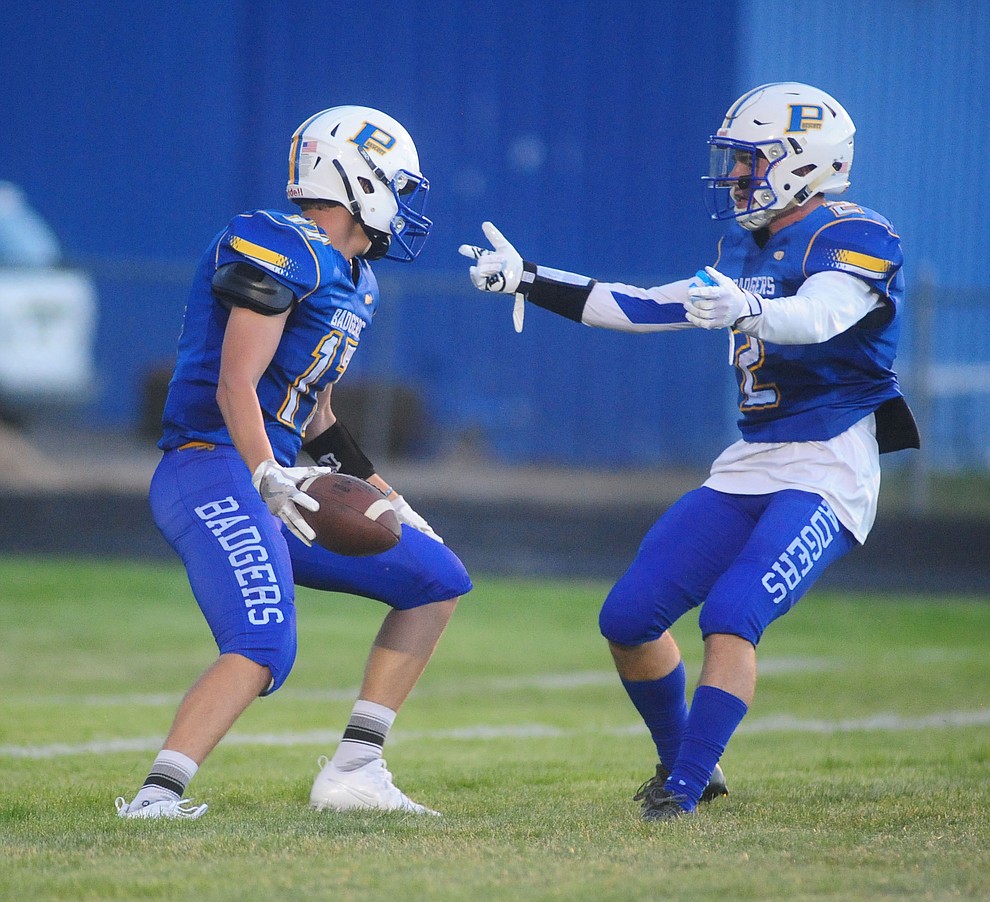 Prescott's Ryan Greene gets congratulated by John Chaffeur after his touchdown run as the Badgers take on the Marcos de Niza in Prescott Friday, August 25. (Les Stukenberg/The Daily Courier).