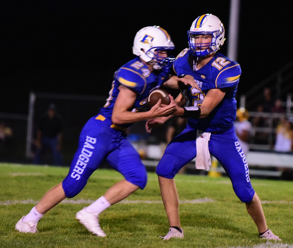 Prescott's Austin Clark hands off as the Badgers take on the Marcos de Niza in Prescott Friday, August 25. (Les Stukenberg/The Daily Courier).