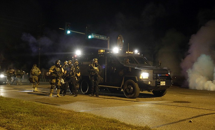 Local police departments will soon have access to grenade launchers, high-caliber weapons and other surplus U.S. military war gear after President Donald Trump signed an order Monday, Aug. 28, 2017, reviving a Pentagon program that civil rights groups say inflames tensions between officers and their communities. (2014 AP Photo/Jeff Roberson)