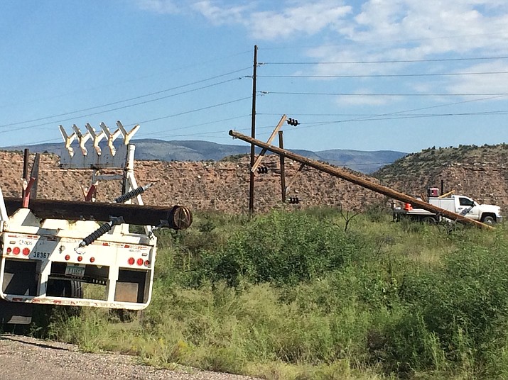 APS makes repairs to downed powerlines on Sycamore Canyon Road, near the former Clark Mansion, Monday morning. Many Clarkdale residents were without power Sunday evening. (VVN/Vyto Starinskas) 