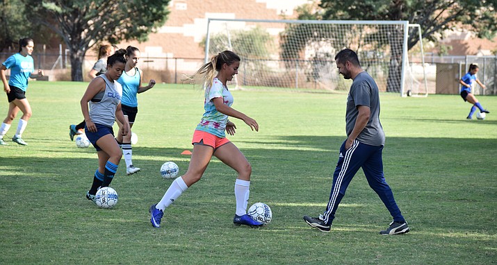 Camp Verde girls soccer players work on dribbling on Tuesday at practice. The Cowboys return 10 of 11 starters from last year’s side. (VVN/James Kelley)