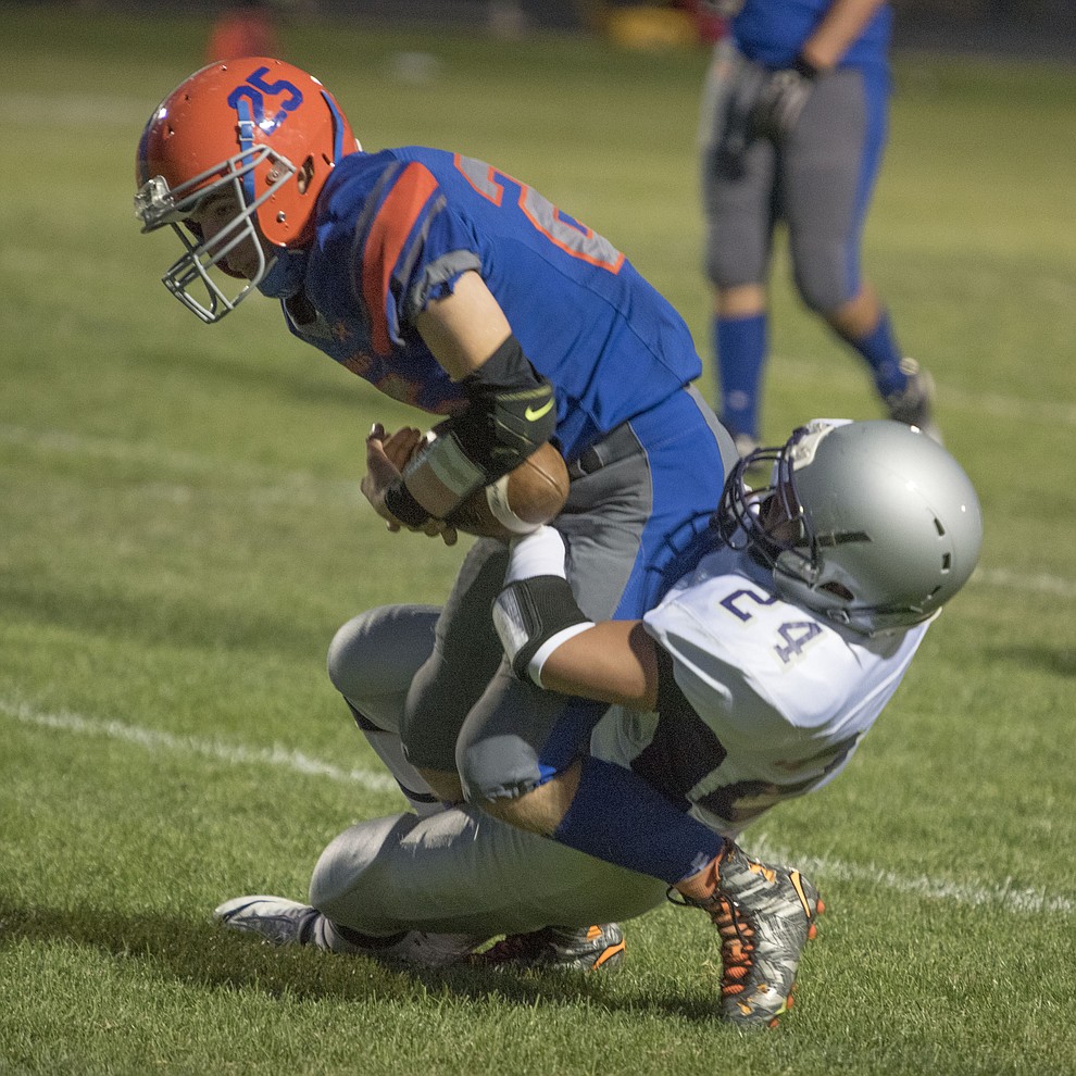 Chino Valley's Canyon Brimhall (25) battles for yardage as the Cougars take on Sedona Red Rock Scorpions Friday, September 1 in Chino Valley. (Les Stukenberg/The Daily Courier)