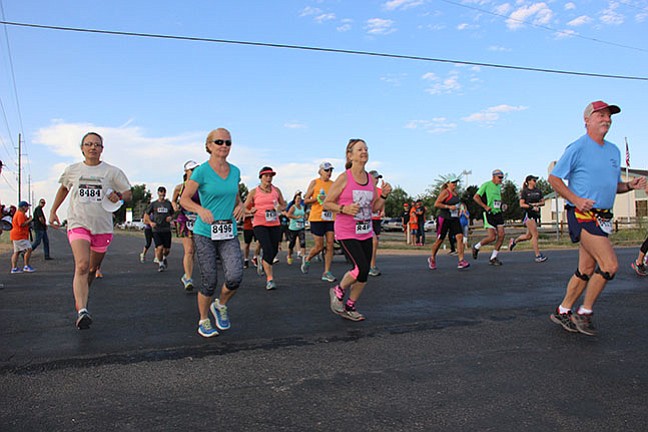 Runners in the 19th annual 10k to benefit Chino Valley High School's cross country team Sept. 2 take off from the corner of West Road 3 North and North Road 1 West near Memory Park in Chino Valley. (Max Efrein/Review)