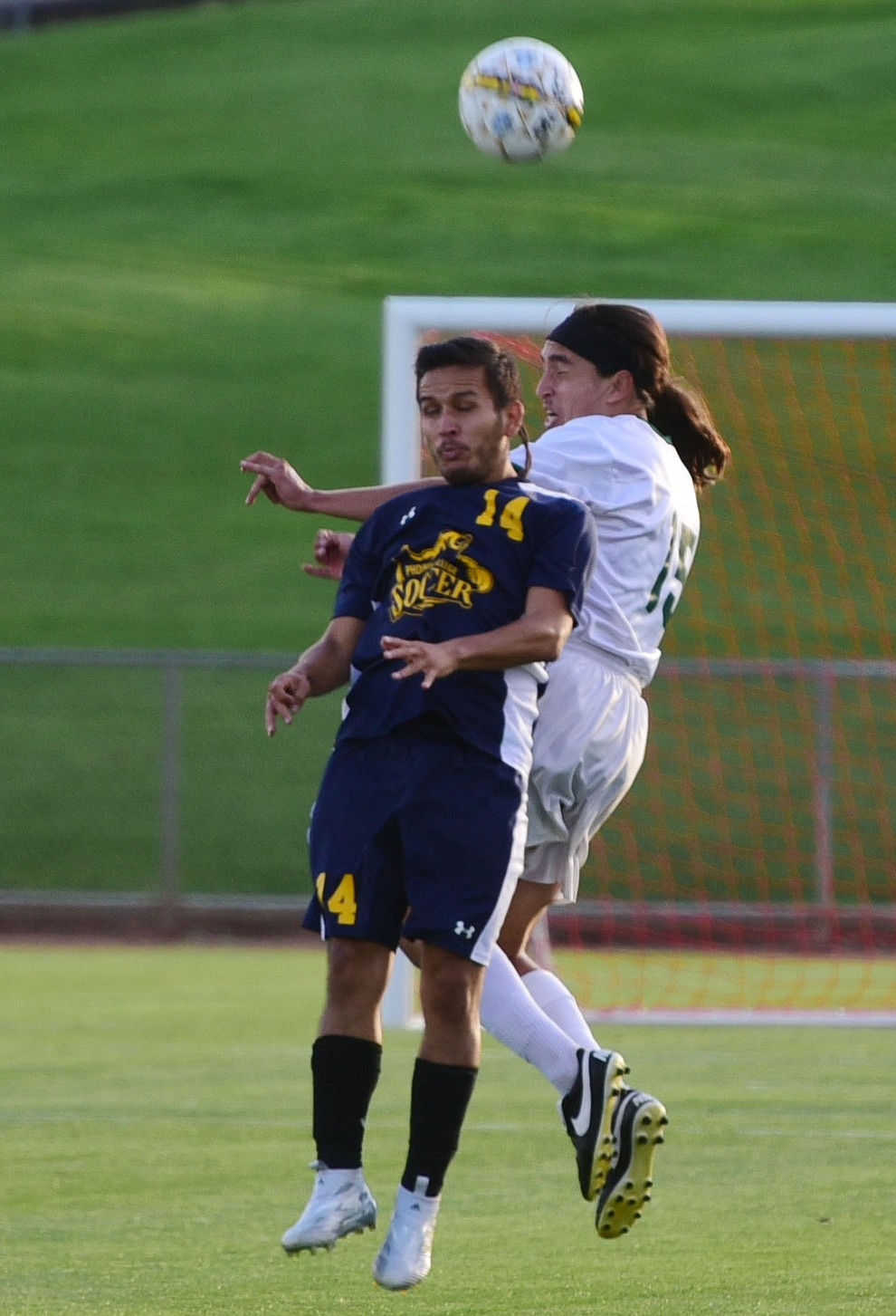 Yavapai's John Kanner heads the ball over Sebastian Aguas as the Roughriders take on the Phoenix College Bears Tuesday night at Mountain Valley Park in Prescott Valley. (Les Stukenberg/Courier).