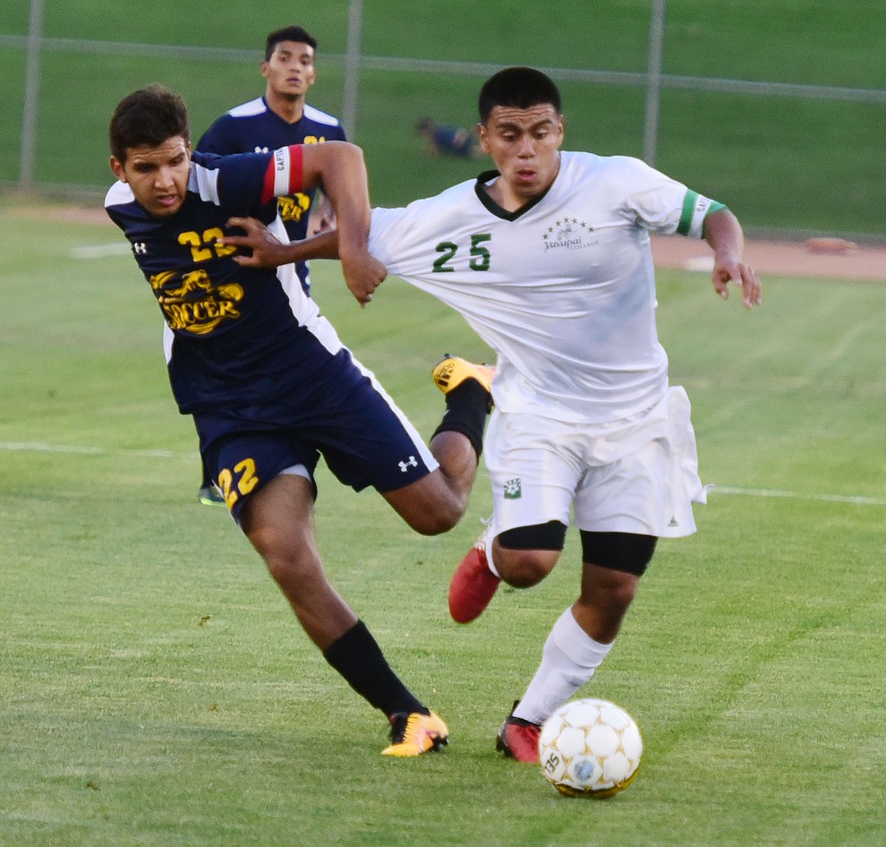 Yavapai's Jose Perez Flores gets held as the Roughriders take on the Phoenix College Bears Tuesday night at Mountain Valley Park in Prescott Valley. (Les Stukenberg/Courier).