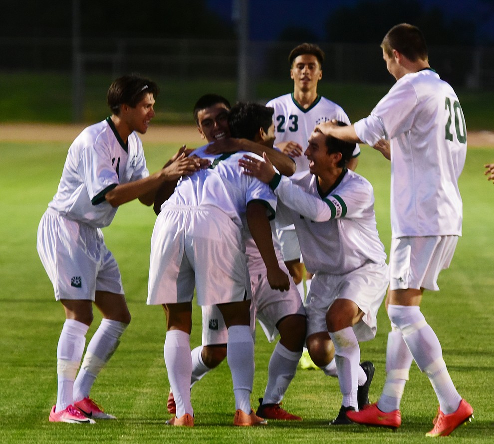Teammates congratulate Yavapai's Alexander Guadron on his second half goal as the Roughriders take on the Phoenix College Bears Tuesday night at Mountain Valley Park in Prescott Valley. (Les Stukenberg/Courier).