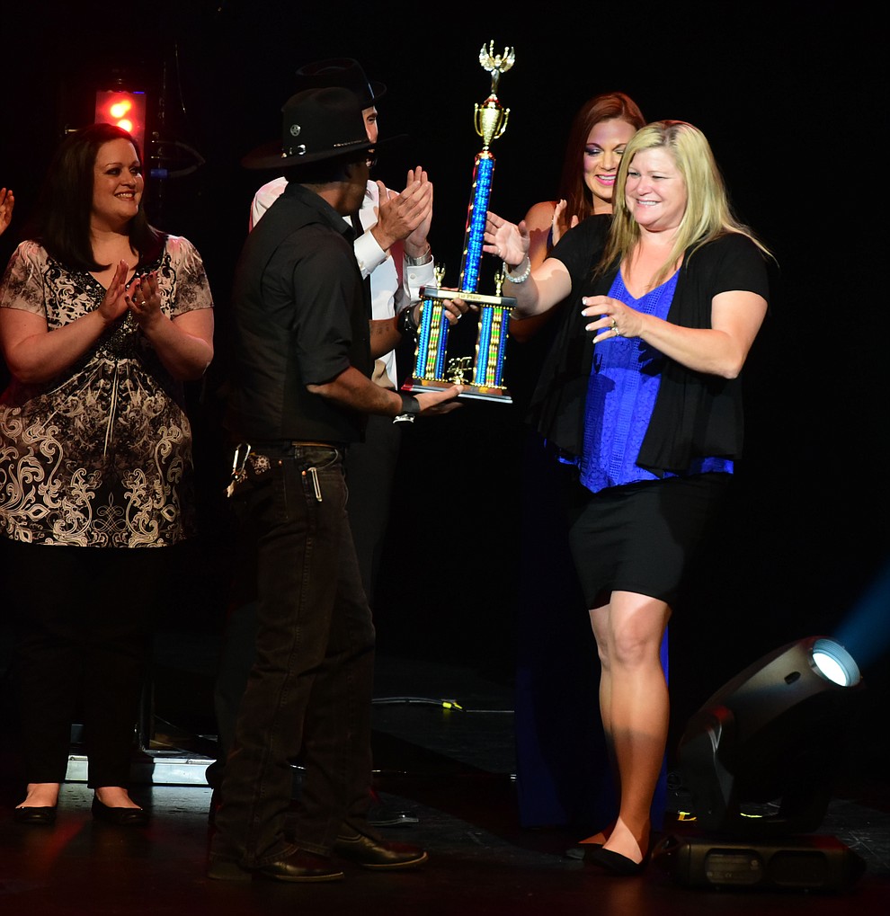 Tiffani Fortney gets the trophy for winning the finale of the 8th annual Prescott Idol competition at the Yavapai College Performance Hall Wednesday, September 6 in Prescott . (Les Stukenberg/Courier).