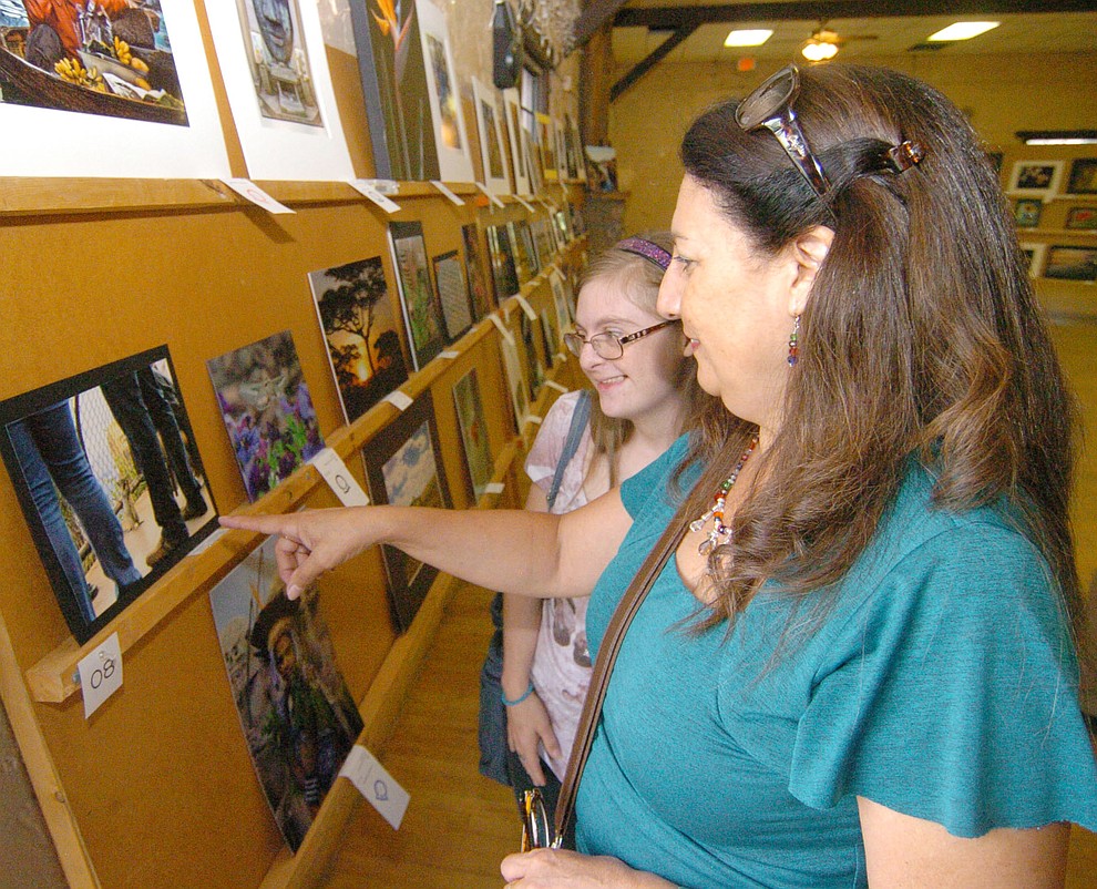 Magdalena and Kristie Waidner look at the photography exhibit at the 2017 Yavapai County Fair at the Prescott Rodeo Grounds Wednesday, September 7 in Prescott . (Les Stukenberg/Courier).