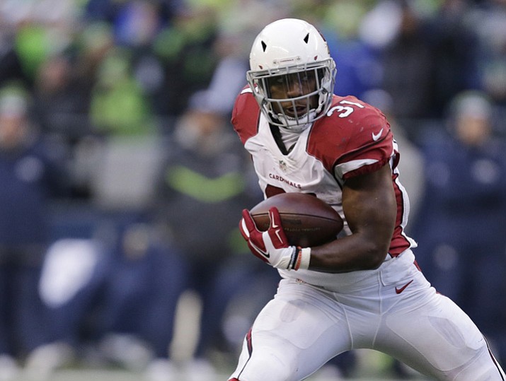 In this Dec. 24, 2016, file photo, Arizona Cardinals’ David Johnson carries the ball against the Seattle Seahawks in the second half in Seattle. (John Froschauer/AP, File)
