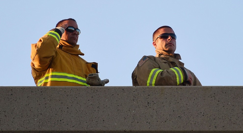Firefighters stand at attention for the National Anthem atop the Civic Center during the Prescott Valley 2017 9/11 Patriot Day Ceremony at the Civic Center in Prescott Valley. (Les Stukenberg/Courier).