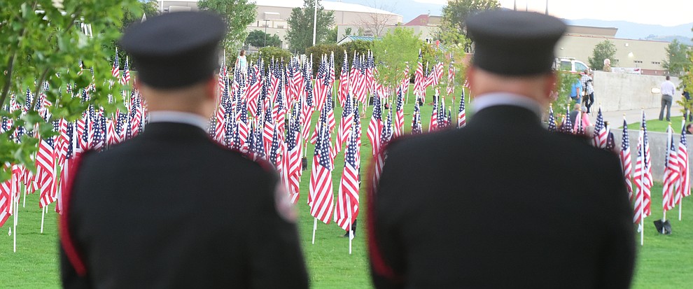 A pair of firefighters look out on the Healing Field during the Prescott Valley 2017 9/11 Patriot Day Ceremony at the Civic Center in Prescott Valley. (Les Stukenberg/Courier).