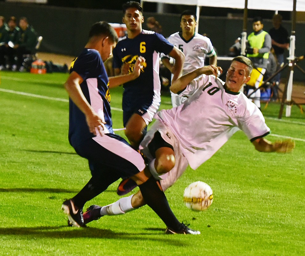 Yavapai's Carlos Quesada gets taken down as the Roughriders played to a 1-1 draw against Phoenix College in a makeup game Thursday, September 14 in Prescott Valley. (Les Stukenberg/Courier).