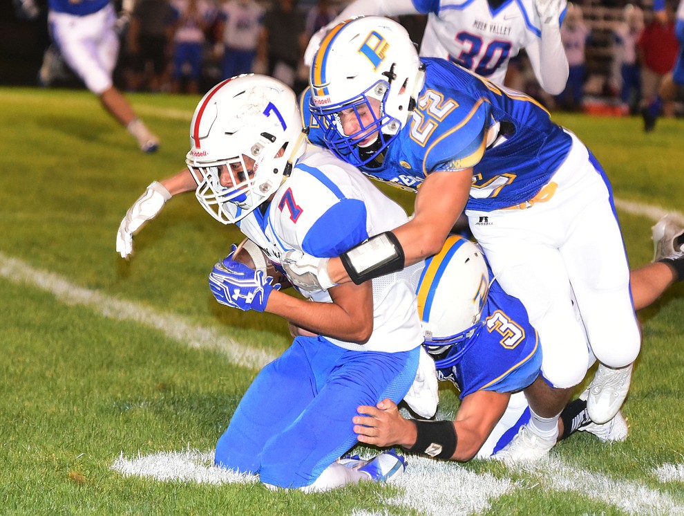 Prescott's Colton Amos (22) and Koby Coates (3) make a tackle as the Badgers play Moon Valley in the 2017 Homecoming game Friday, September 15 in Prescott. (Les Stukenberg/Courier).