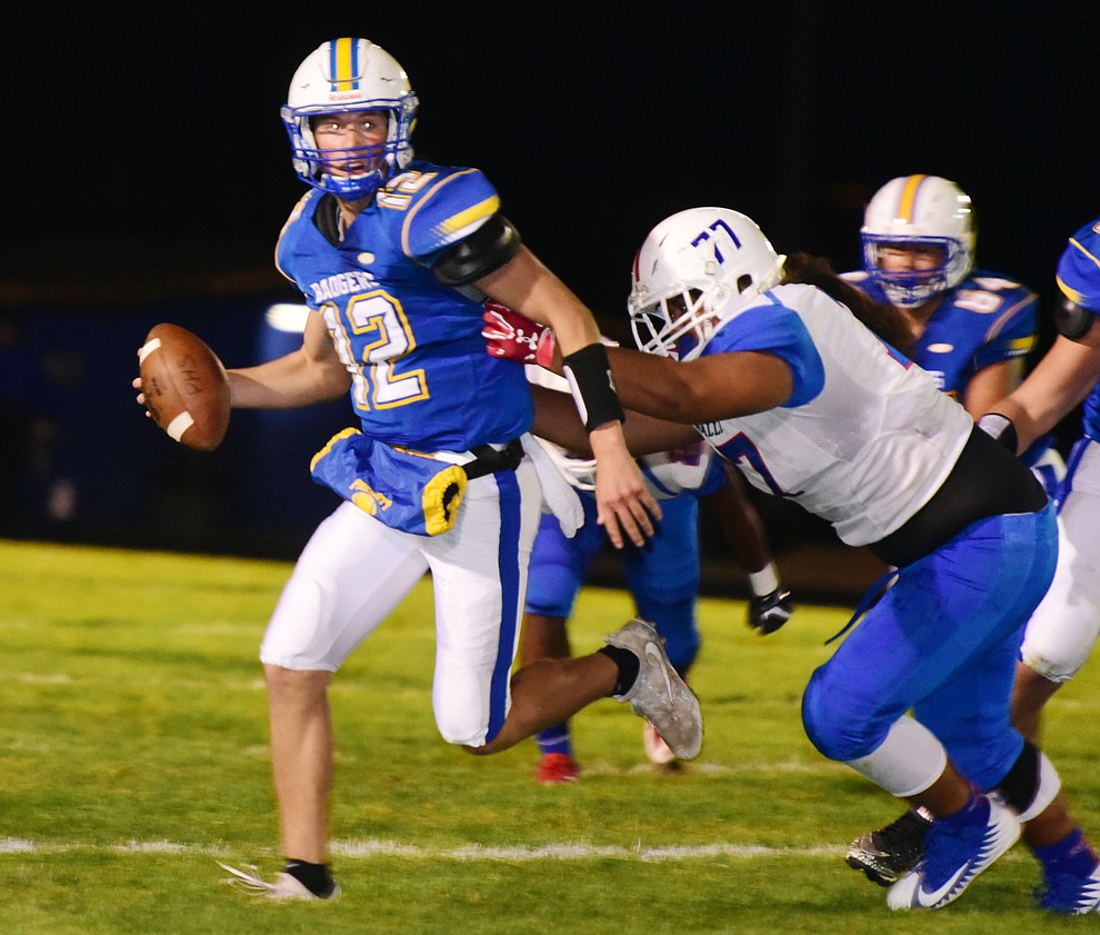 Prescott's Austin Clark (12) scrambles out of the pocket as the Badgers play Moon Valley in the 2017 Homecoming game Friday, September 15 in Prescott. (Les Stukenberg/Courier).
