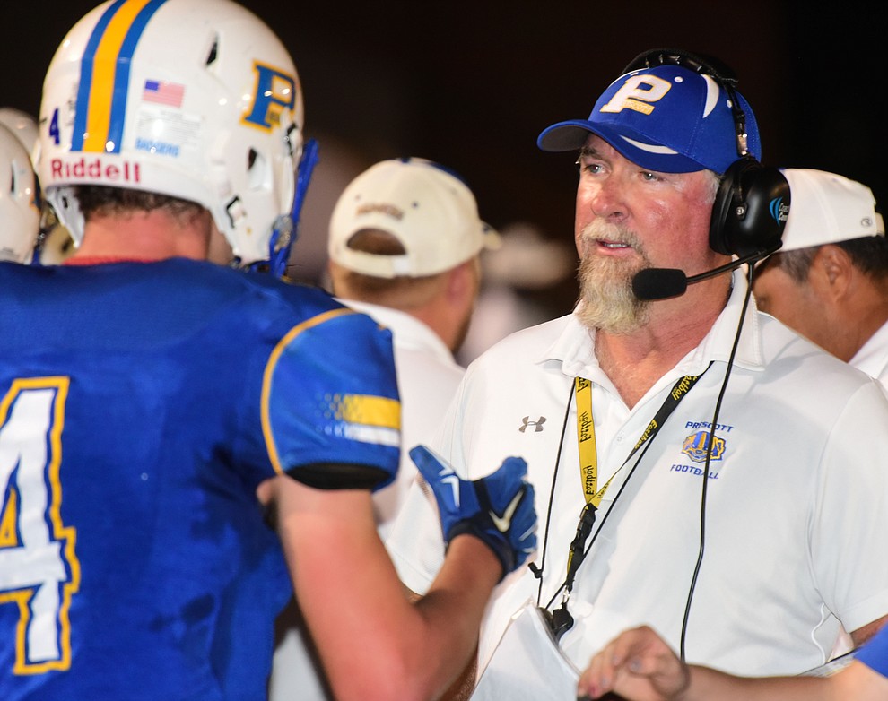 Prescott Head Coach Michael Gilpin talks to Aaron Greene on the sidelines as the Badgers play Moon Valley in the 2017 Homecoming game Friday, September 15 in Prescott. (Les Stukenberg/Courier).