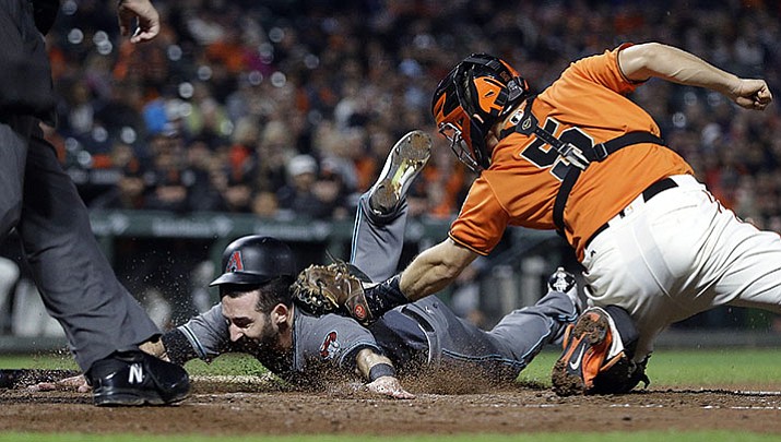 San Francisco Giants catcher Nick Hundley, right, tags out Arizona Diamondbacks' Daniel Descalso in the second inning of a baseball game Friday, Sept. 15, in San Francisco. Descalso attempted to score on a fielder's choice by Arizona's A.J. Pollock.