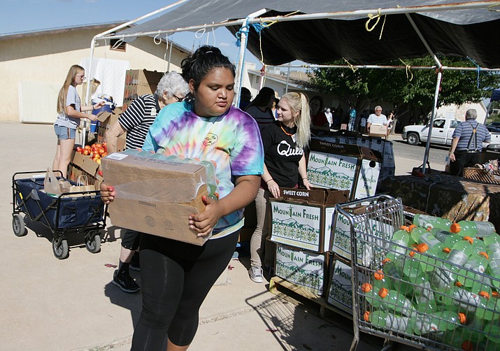 South Verde High School students, such as senior Adrianna Campos, pictured above, volunteer one Wednesday each month at the Camp Verde Seventh-Day Adventist Church’s food bank. (Photos by Bill Helm)