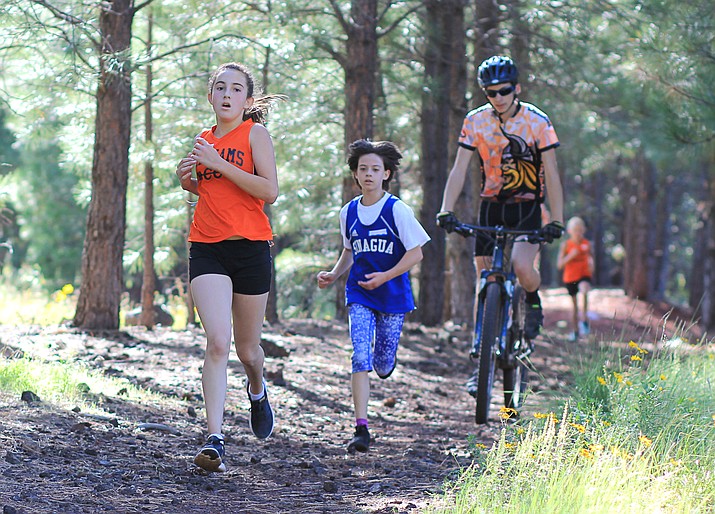 Brayden Larimore passes a runner on her way to a third place finish in the Williams cross-country invitational.