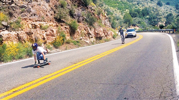 A car follows skateboarders down Highway 89A as a safety precaution. Law enforcement says as long as they don’t impede traffic, skateboarding on state highways is legal.  (Vyto Starinskas/WNI)