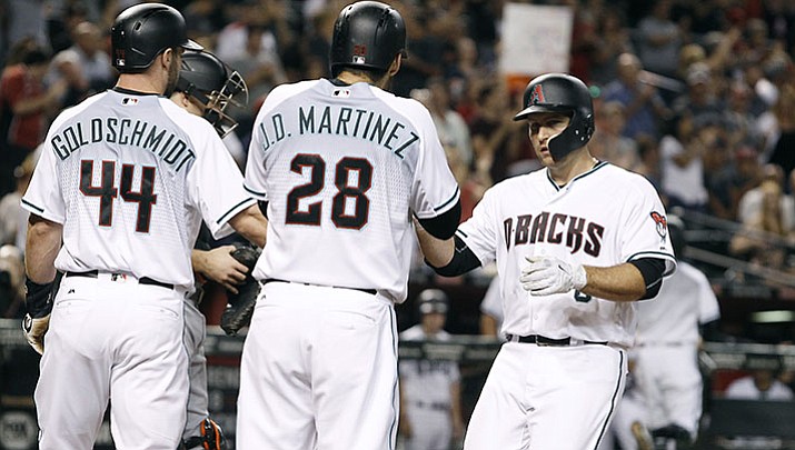 Arizona Diamondbacks' Chris Iannetta, right, is congratulated by teammates Paul Goldschmidt (44) and J.D. Martinez (28) after his three-run home run against the Miami Marlins during the first inning Friday, Sept. 22, in Phoenix.