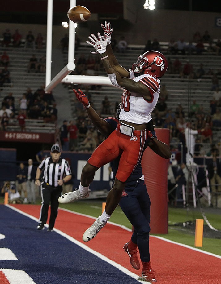 Arizona safety Demetrius Flannigan-Fowles (6) defends the pass intended for Utah wide receiver Siaosi Wilson (80) in the first half during an NCAA college football game, Friday, Sept. 22, in Tucson. Wilson was ruled out of bounds on the play.