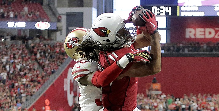 Arizona Cardinals wide receiver Larry Fitzgerald (11) pulls in the game winning touchdown as San Francisco 49ers cornerback Rashard Robinson defends during overtime of an NFL football game, Sunday, Oct. 1, in Glendale. The Cardinals won 18-15. (Rick Scuteri/AP)