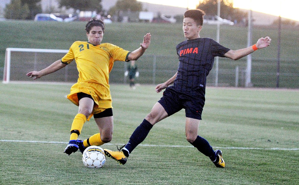 Yavapai's Isaac Arellano (21) goes for the ball as the Roughriders take on Pima Community College in soccer Tuesday night in Prescott Valley. (Les Stukenberg/Courier)