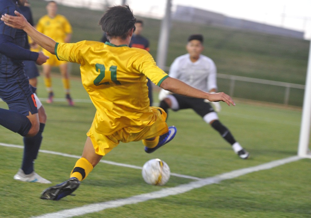 Yavapai's Isaac Arellano (21) takes a shot on goal as the Roughriders take on Pima Community College in soccer Tuesday night in Prescott Valley. (Les Stukenberg/Courier)