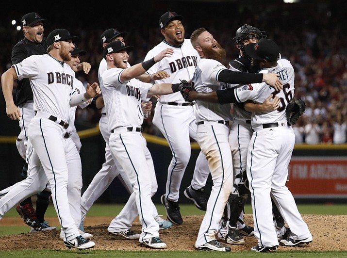 The Arizona Diamondbacks celebrate after the National League wild-card playoff game against the Colorado Rockies on Wednesday, Oct. 4, 2017, in Phoenix. The Diamondbacks won 11-8 to advance to an NLDS against the Los Angeles Dodgers. (Matt York/AP)
