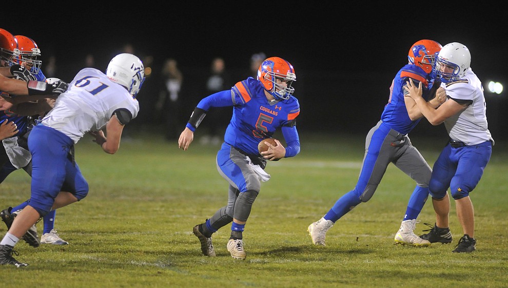 Chino Valley's Michael Paulus runs for a first down as the Cougars take on the Kingman Bulldogs Friday, October 6. (Les Stukenberg/Courier)