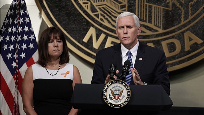Vice President Mike Pence, accompanied his wife, Karen, speaks in Las Vegas on Saturday, Oct. 7, 2017, following a unity prayer walk honoring the victims of last weekend’s massacre. 