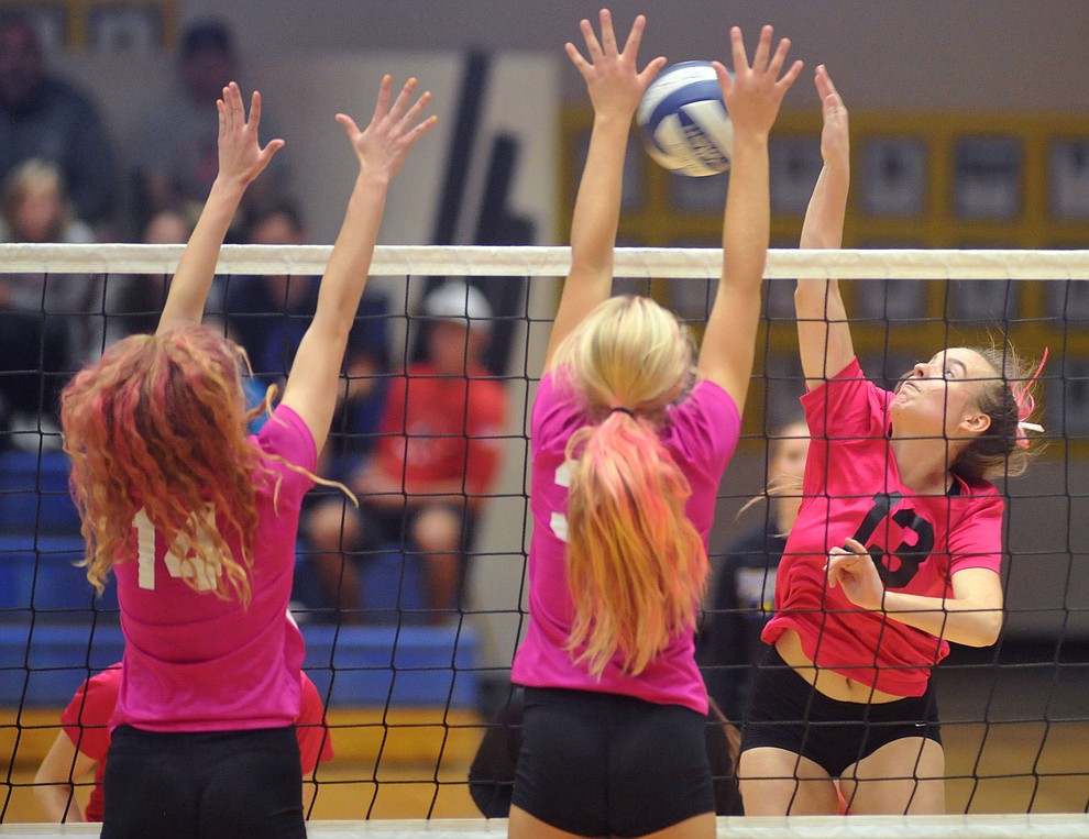 Bradshaw Mountain's Jordyn Moser (13) goes for a kill on Daphne Skinner (14) and Katherin Radavich (34) as the Bears traveled to crosstown rival Prescott for a volleyball matchup Monday night. (Les Stukenberg/Courier)