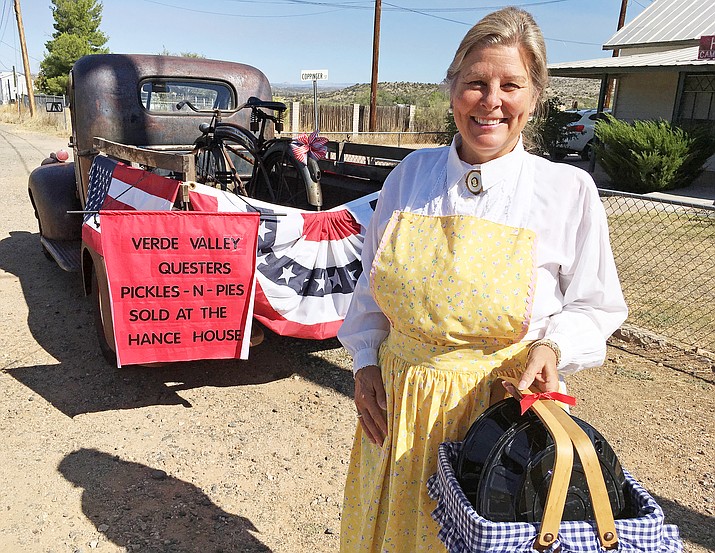 Nancy Futral of the Verde Valley Questers, pictured, with pickles and pies that represent the group’s annual pickles and pies fundraiser. All money spent on pickles and pies Saturday will be used to restore the Historic Hance House on Coppinger Street, across from Fort Verde State Historic Park. (Photo by Bill Helm)