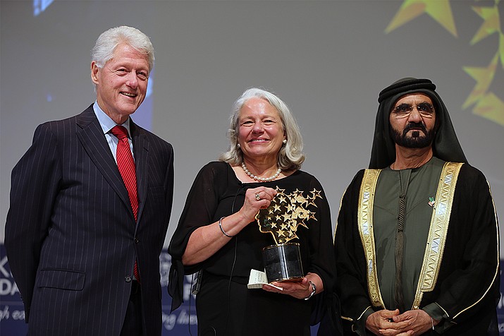 Nancie Atwell, a teacher from Maine, poses with former President Bill Clinton and Sheikh Mohammed bin Rashid Al Maktoum, Ruler of Dubai, after she won the $1 million Global Teacher Prize in March 2015. Atwell has been charged for a third time with shoplifting, this time allegedly stealing a $28 dog leash. (AP File Photo/Kamran Jebreili)

