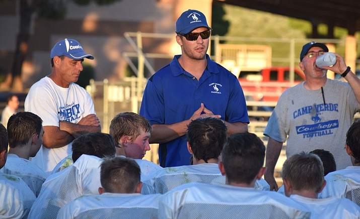 Camp Verde assistant coach Jake Spleiss addresses the Cowboys’ after their scrimmage against Scottsdale Prep. Spleiss was a star football and basketball player at CV.  (VVN/James Kelley)