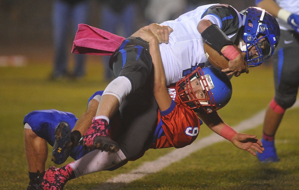 Bagdad quarterback Israel Loveall (1) runs into Clinton Swink (9) as the Sultans faced the Mayer Wildcats Friday night in a matchup of top 4 teams in the AIA 1A rankings in Mayer. (Les Stukenberg/Courier)