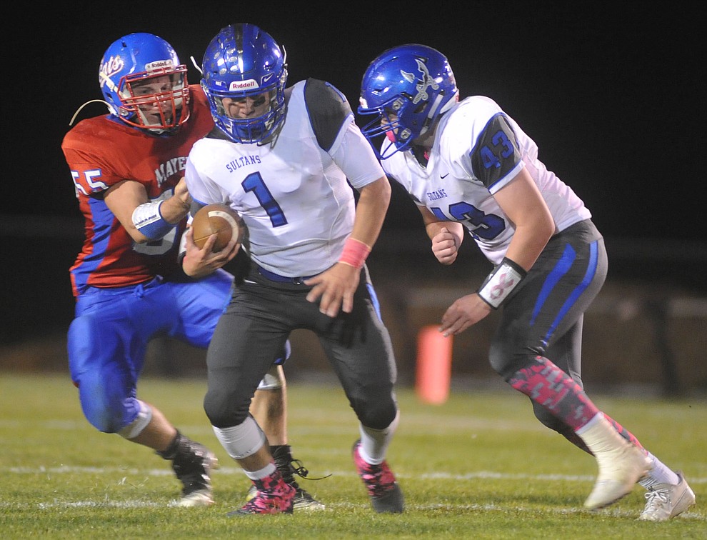 Mayer's Dacodah Jensen (55) has Israel Loveall in the backfield as the Wildcats faced the Bagdad Sultans Friday night in a matchup of top 4 teams in the AIA 1A rankings in Mayer. (Les Stukenberg/Courier)