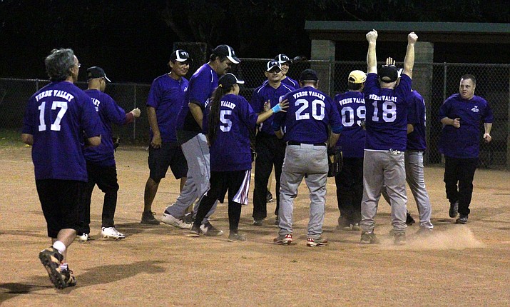 Verde Valley Diamondbacks celebrate their win over the varsity Mingus Union softball on Thursday night at Butler Park in Camp Verde. Later this month they will compete at the Special Olympics Fall Classic in Peoria. (VVN/James Kelley)