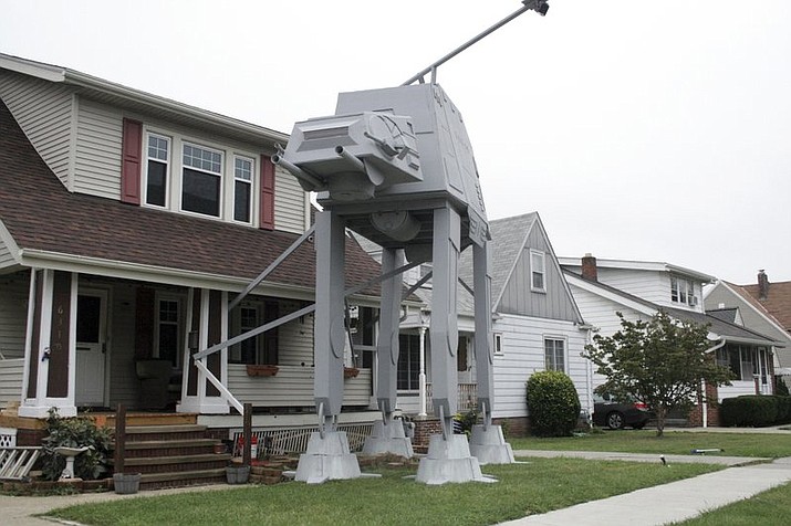 Parma, Ohio homeowner Nick Meyer used wood, hard foam and plastic barrels to build a replica four-legged All Terrain Armored Transport, or AT-AT walker. He says he enjoys the “Star Wars” movies but isn’t a fanatic and simply thought the display would be unique. (Patrick Cooley/The Plain Dealer-Cleveland.com via AP)

